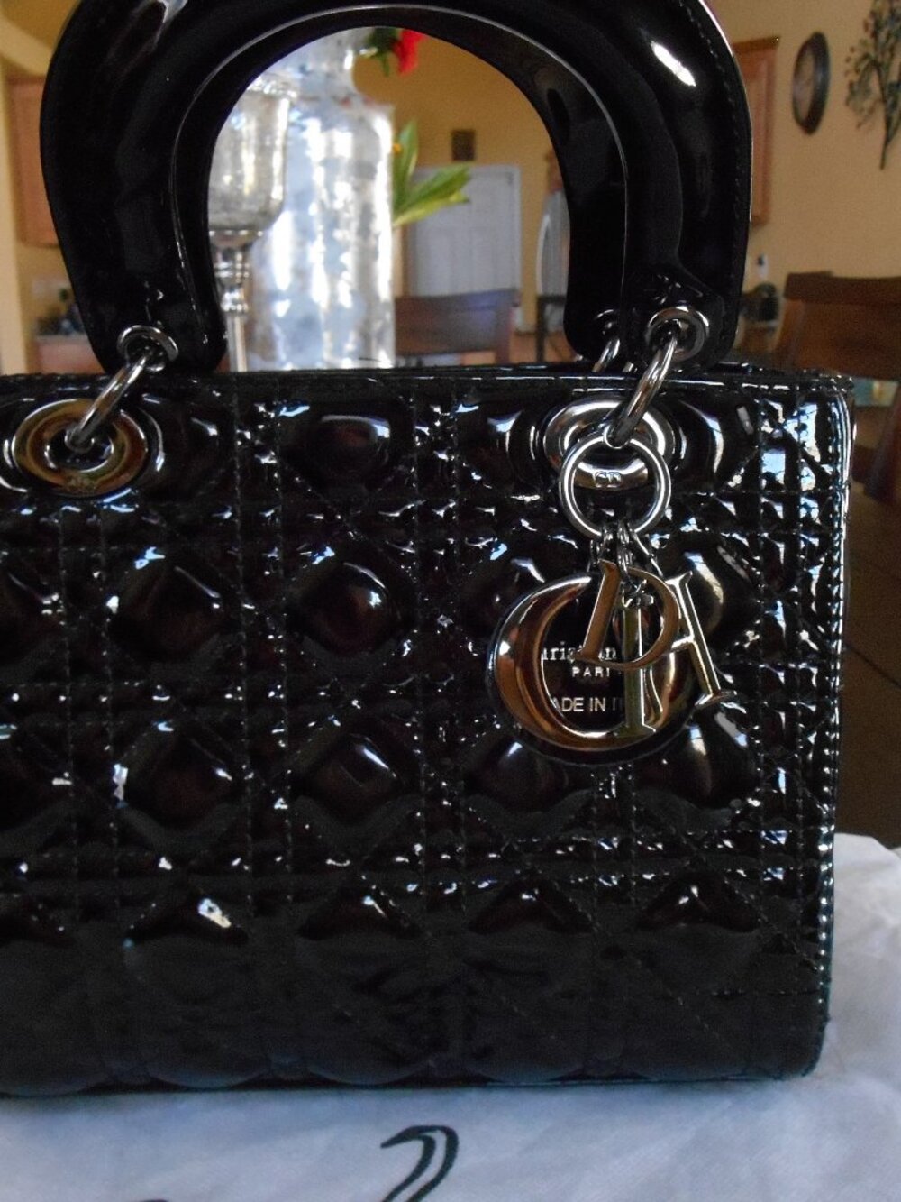 High fashion black quilted faux leather bag with a zip closure and double handle